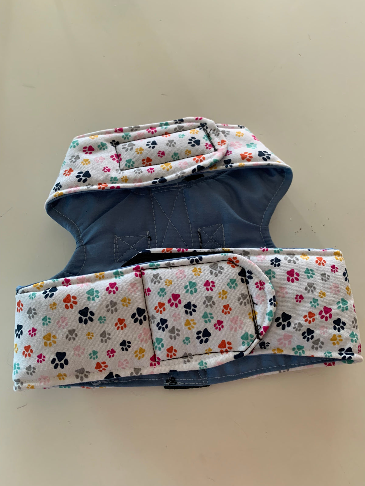 Paw prints on white pet harness