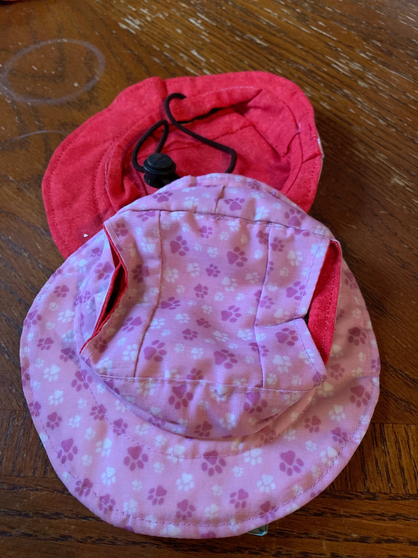 Paw prints on pink pet bucket hat