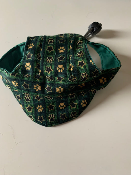 Paw prints and stars on green pet hats