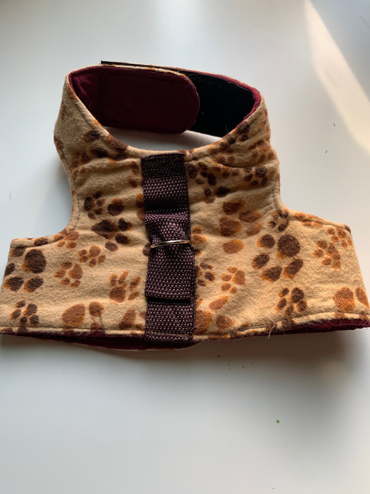 Paw prints on brown pet walking vest harness in