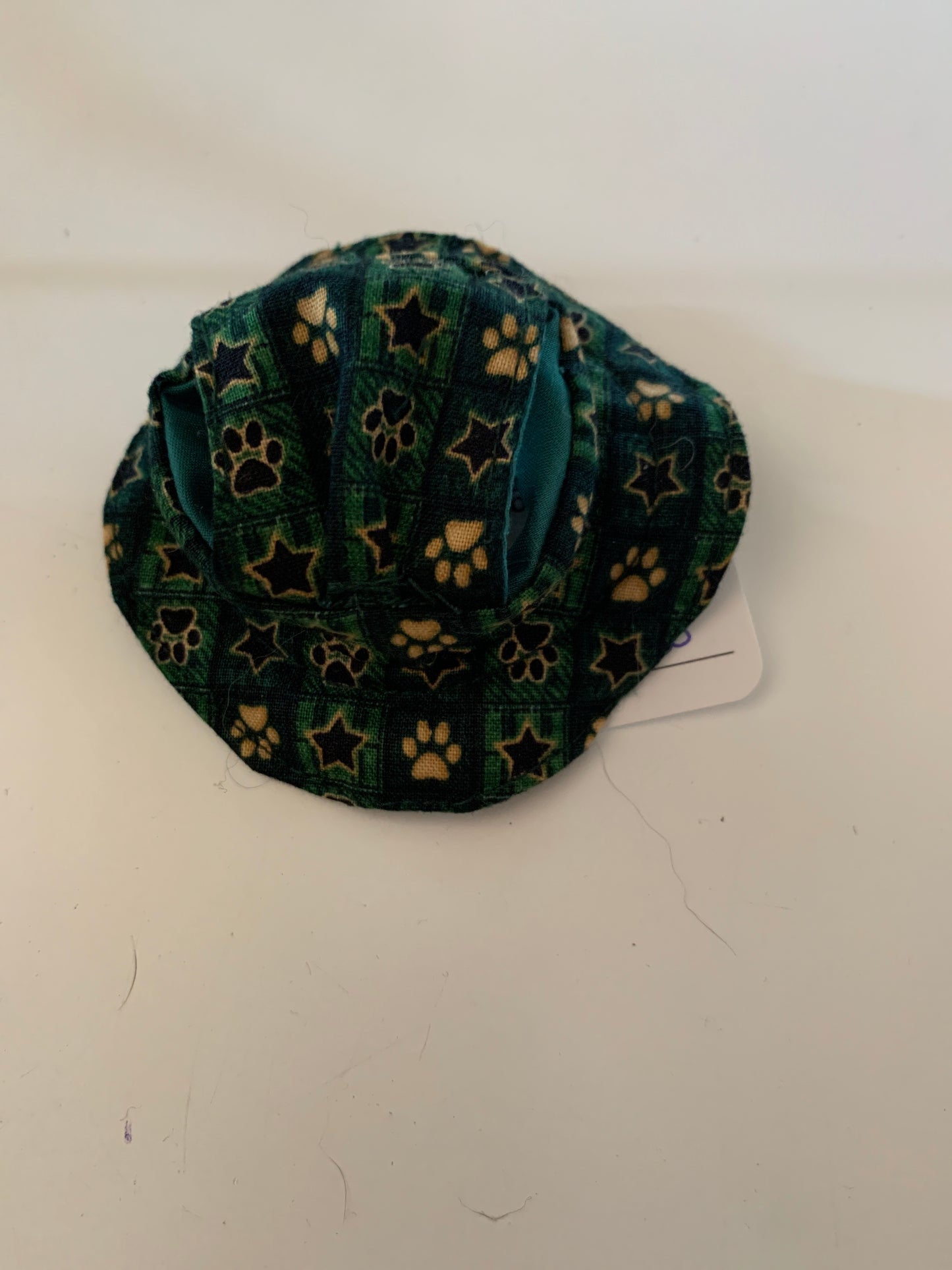Paw prints and stars on green pet hats