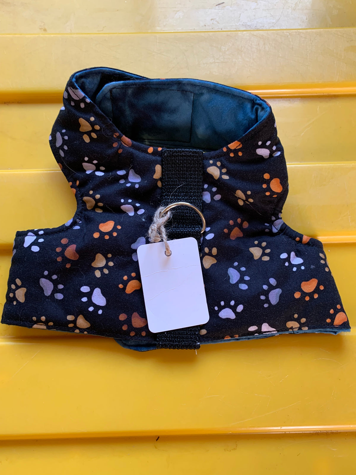 Paw prints on black pet harness