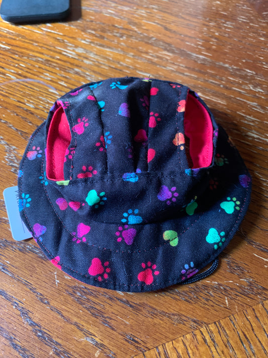 Multicolored paw prints on black pet bucket hat
