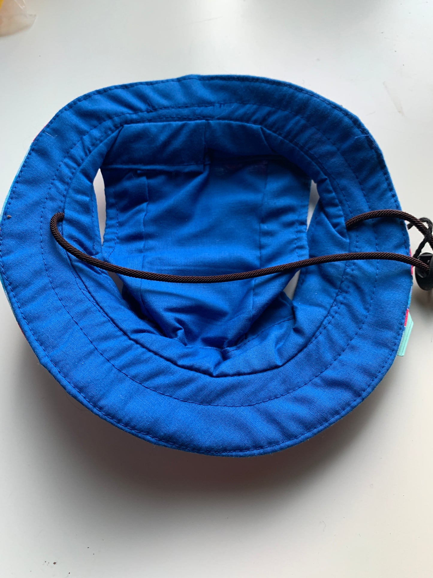 Blue flowers on red pet bucket hat