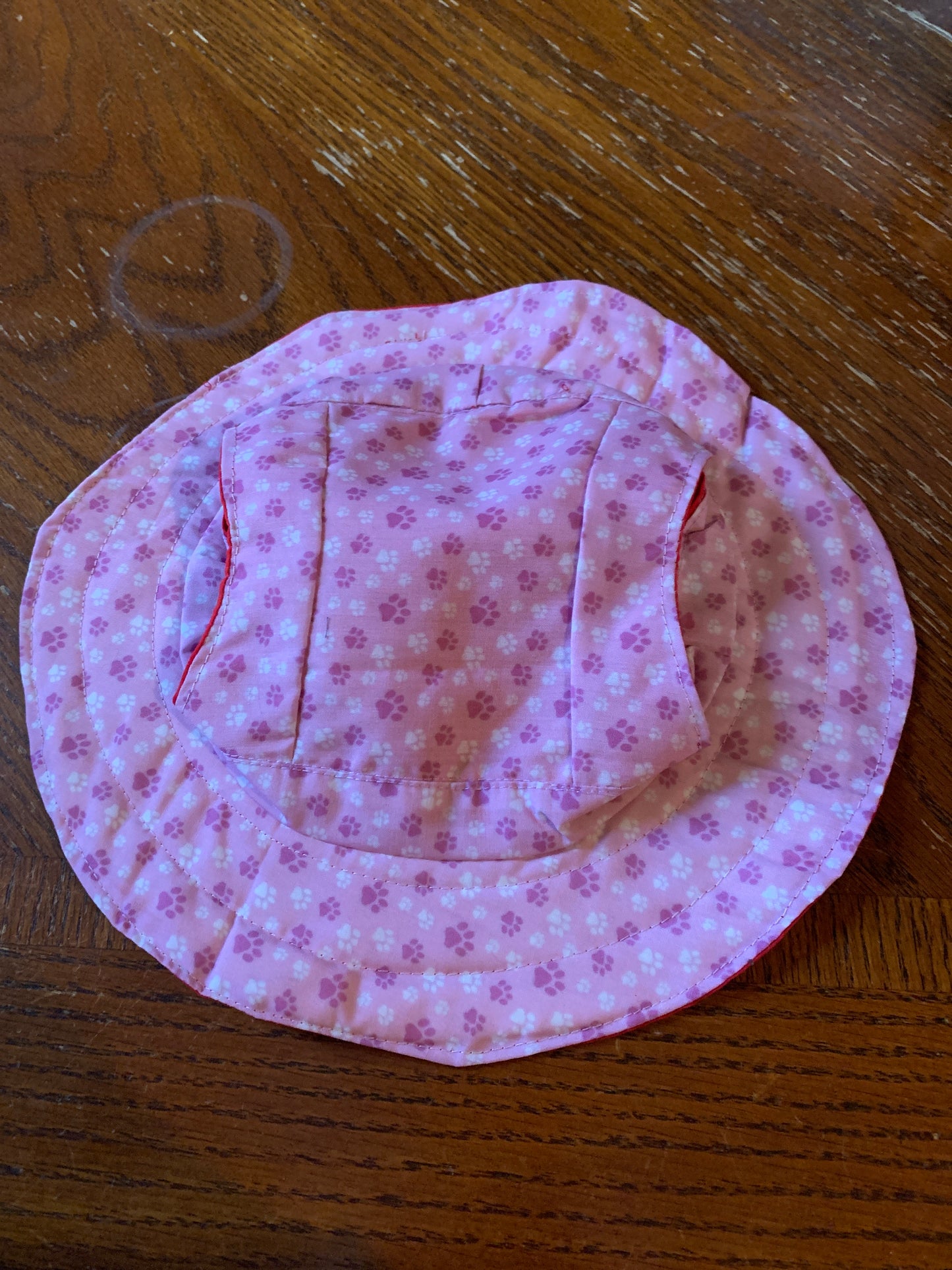 Paw prints on pink pet bucket hat