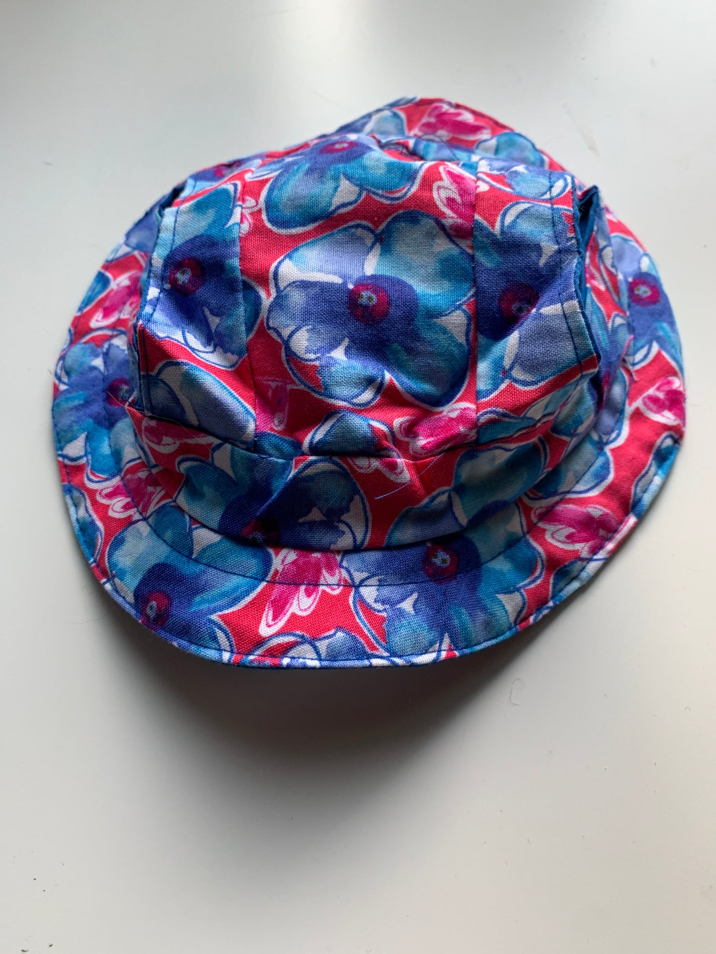 Blue flowers on red pet bucket hat