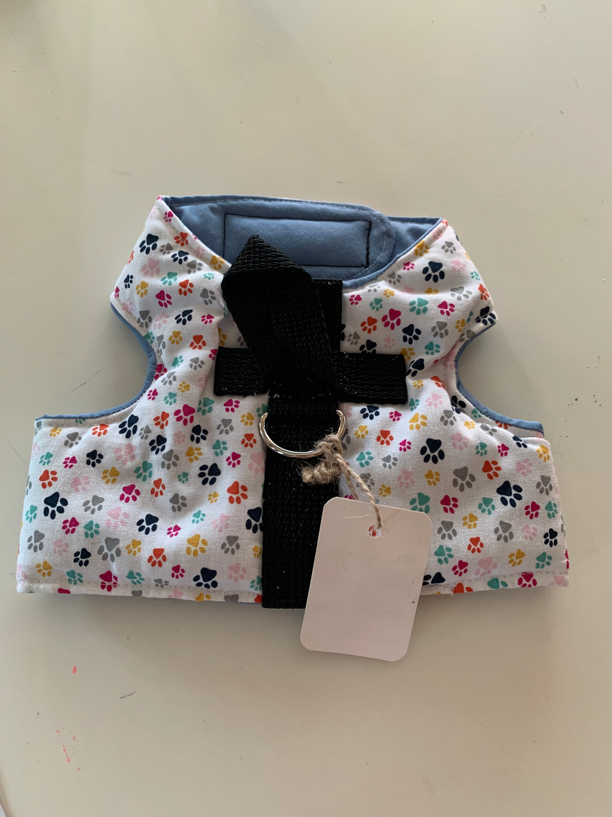 Paw prints on white pet harness